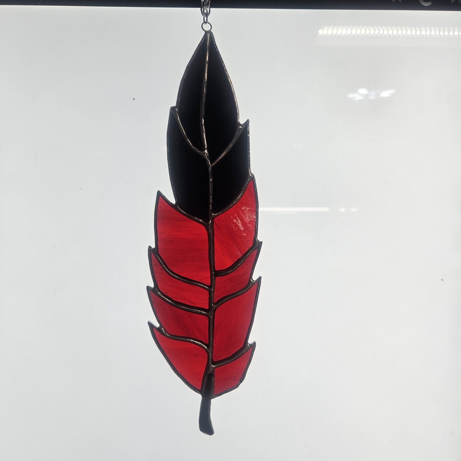 Red and black stained glass feather