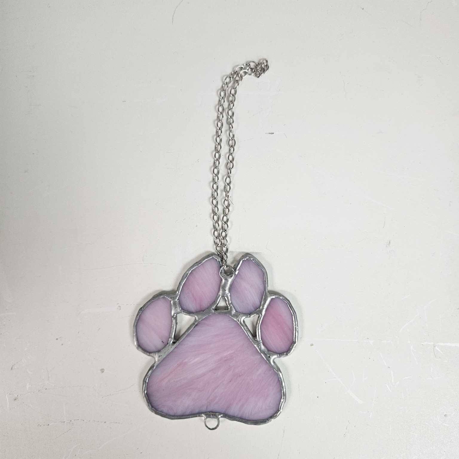 Pink stained glass paw print